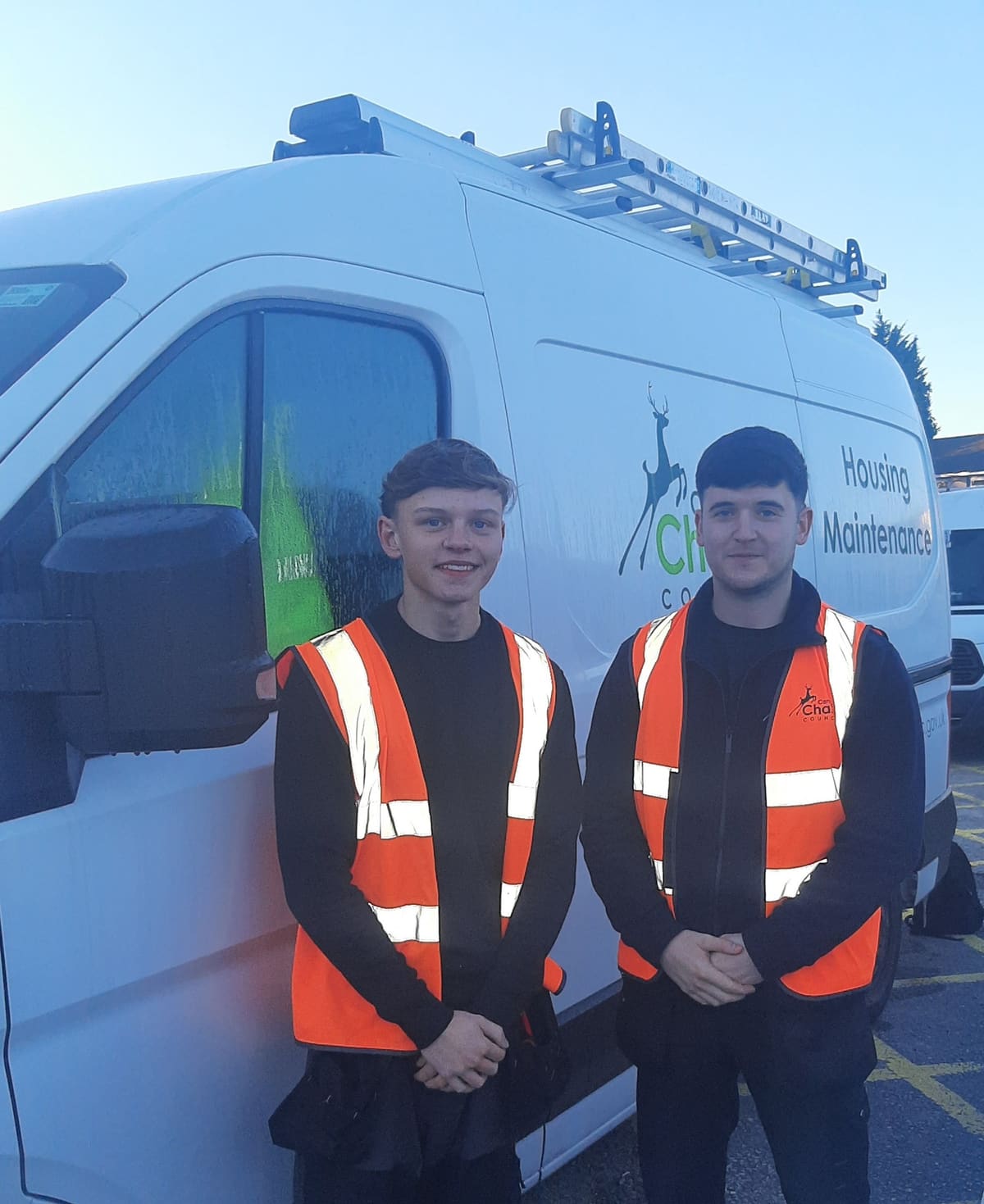 Ollie Kite and Conor Edwards beside a Cannock Chase Council housing maintenance van