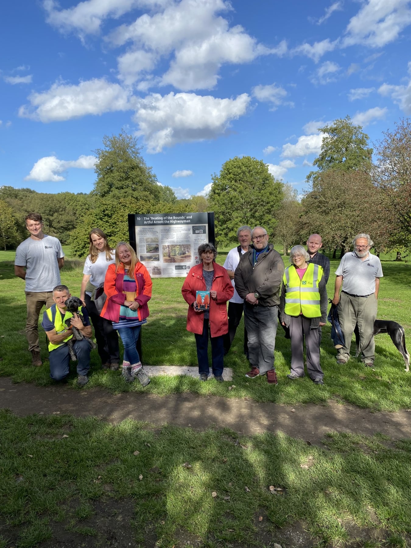 A group gathered beside an interpretation panel during the Cannock Park heritage-trail opening